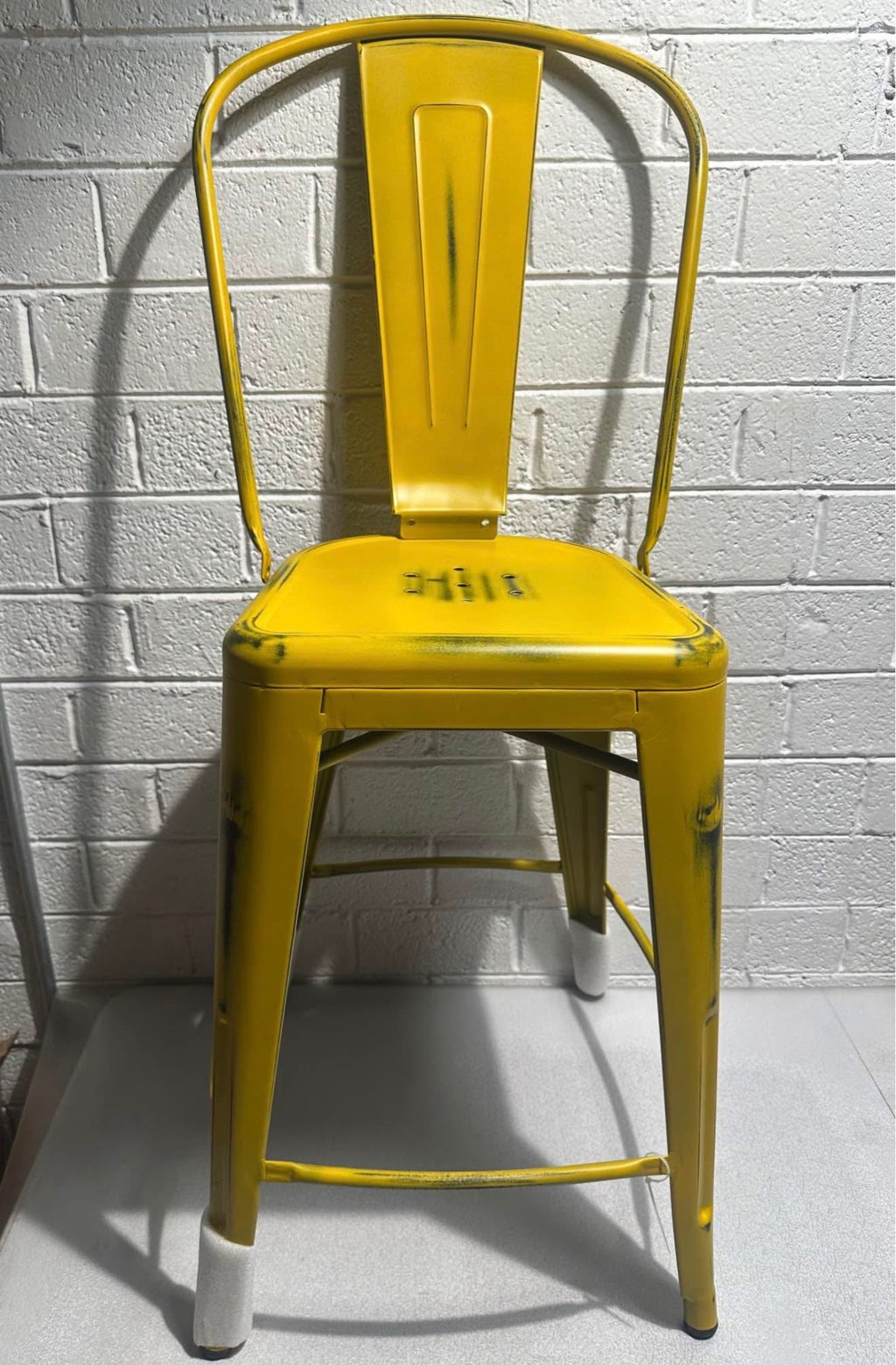 Distressed Yellow Metal Stool with Back